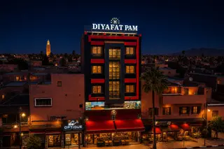 The Diyafat Pam aparthotel facade and its illuminated sign in Khenifra